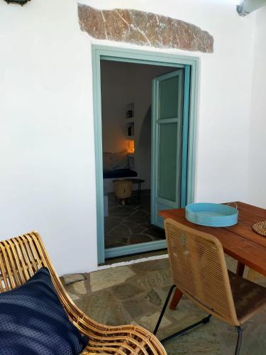 a dining room with a table and a chair at Amorgos Elegant Houses, 6 Villas in Amorgos