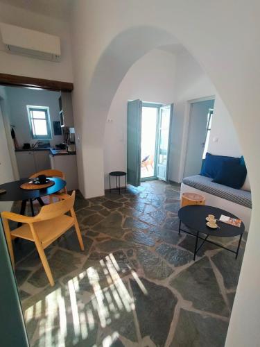 a living room with a couch and a table at Amorgos Elegant Houses, 6 Villas in Amorgos