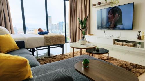 a living room with a bed and a tv at SkyPool 2BR 9pax Premium Suite@Beacon @Georgetown @Penang in George Town
