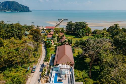 an aerial view of a house with a pool and a windmill at Baan Taranya Koh Yao Yai Resort in Ko Yao Yai