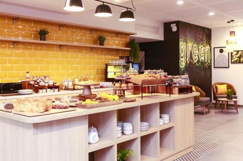 a bakery with a counter with food on it at Appart Hotel Odalys City Angers Centre Gare in Angers