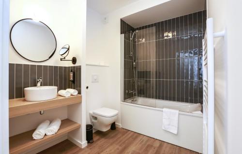 a bathroom with a sink and a toilet and a mirror at Odalys City Angers Centre Gare in Angers