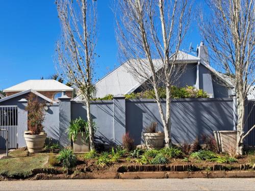 a white house with trees in front of it at No. Forty2 on President in Parys