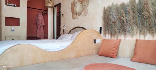 a bedroom with a large bed with a wooden head board at Bstudio in APEC Mandala Mũi Né in Phan Thiet