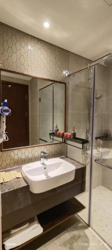 a bathroom with a sink and a shower at Bstudio in APEC Mandala Mũi Né in Phan Thiet
