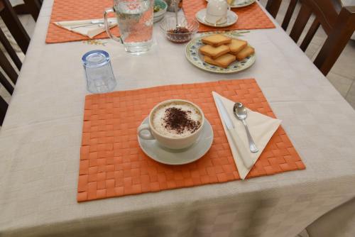 a table with a cup of coffee and a plate of food at B&B Il Vicoletto Del Casale in Centola