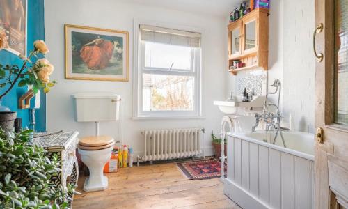 a bathroom with a toilet and a sink and a tub at Three Bedroomed Victorian Family House, Garden in Brighton & Hove
