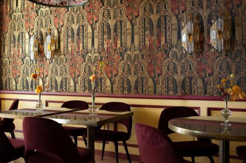 a room with two tables and chairs and a wallpaper at Grand Hotel et de Milan - The Leading Hotels of the World in Milan