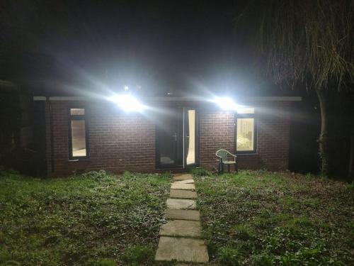 a brick house at night with lights on it at Holiday Out House in London