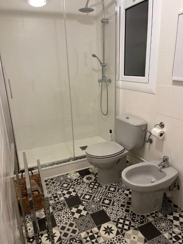 a bathroom with a shower and a toilet and a sink at LETS HOLIDAYS Attractive apartment in costa brava in Tossa de Mar
