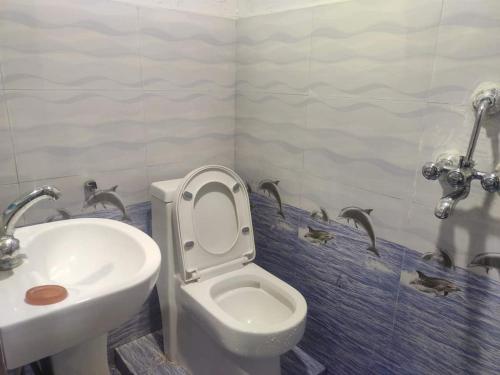 a bathroom with a toilet and a sink at Hotel Swornim Namobuddha in Dhulikhel
