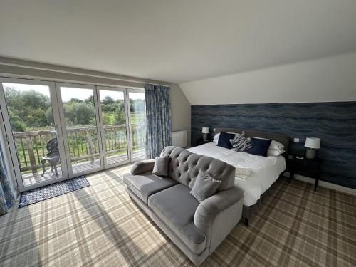 a large bedroom with a bed and a couch at Ocean Retreat in Filey