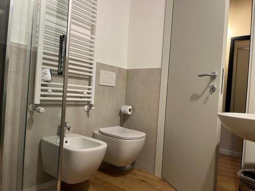 a bathroom with a toilet and a sink at Locanda Gatto Bianco in Bergamo