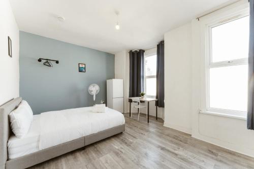 a white bedroom with a bed and a window at Leyton Comfy Double rooms -50 in London