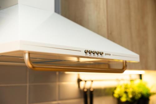 a white stove top hood in a kitchen at Valaoritou 3 Luxury Rooms in Thessaloniki