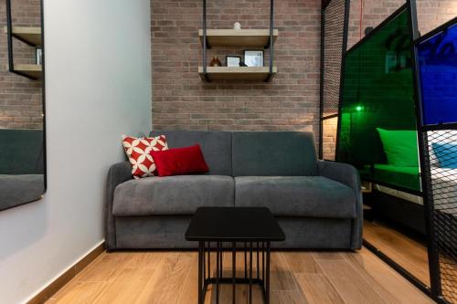 a living room with a couch and a table at Valaoritou 3 Luxury Rooms in Thessaloniki
