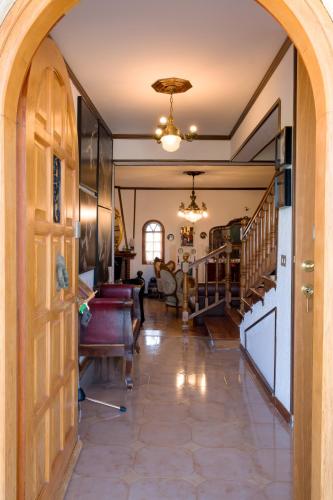 a hallway with an archway leading to a living room at Archontiko Alexandros Luxury Suites in Kardiá