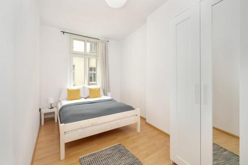 a small bedroom with a bed and a window at Bright & Comfortable Apartment Garbary 35 Poznań Old Town by Renters in Poznań