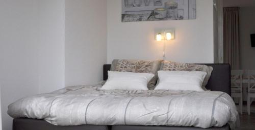 a bed with two pillows on it in a room at Bed & Breakfast Inn Drenthe in Fluitenberg