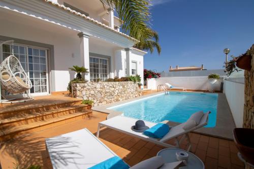 a villa with a swimming pool and a house at Villa Ílios - Porto de Mós, Lagos in Lagos