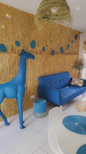 a living room with a blue couch and a blue dog at gîte de charèze in Seigy
