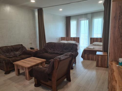 uma sala de estar com um sofá e uma cama em MikePalace em Batumi