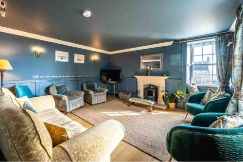 a living room filled with furniture and a fireplace at The Millie Luxury Five Star with Sea View in Burghead