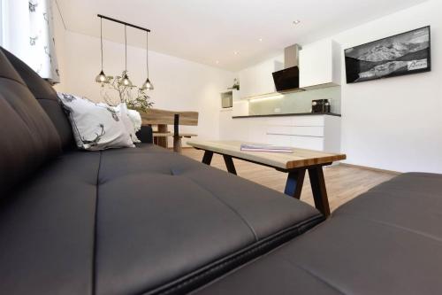 a living room with a couch and a table at Ferienwohnung Saxenhammer in Vandans