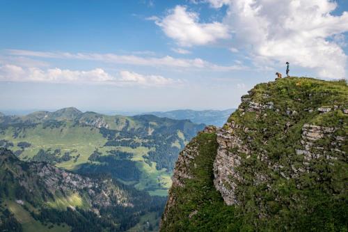 a man standing on top of a mountain at Ferienbauernhof Berlinger in Au im Bregenzerwald