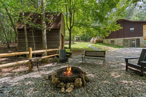 a fire pit in front of a log cabin at Bit A Trees in Blairsville
