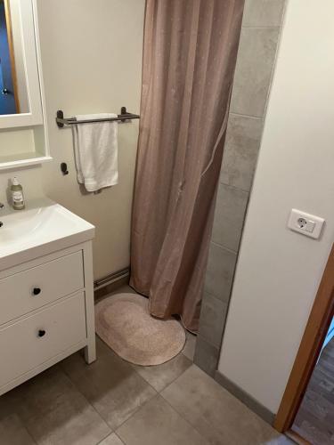 a bathroom with a shower with a shower curtain at Sigtún 4 in Patreksfjörður