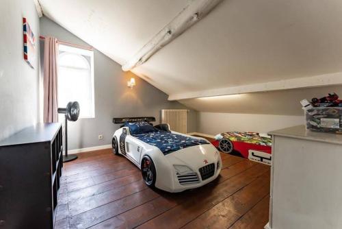 a bedroom with a race car bed in a attic at Maison au cœur de Valence avec parking privé in Valence