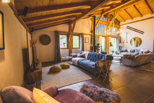 a large living room with couches and a tv at Hot tub, Sauna, Private shuttle and Privacy - 14 ppl - Stunning Ferme Liberté in Les Gets