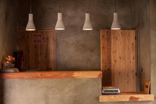 a room with a counter with three pendant lights at Lava Homes in Santo Amaro