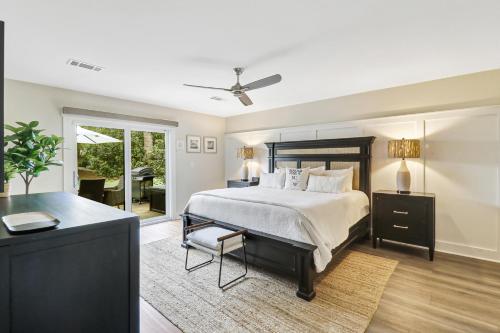 a bedroom with a bed and a dresser and a table at 672 Queens Grant in Hilton Head Island