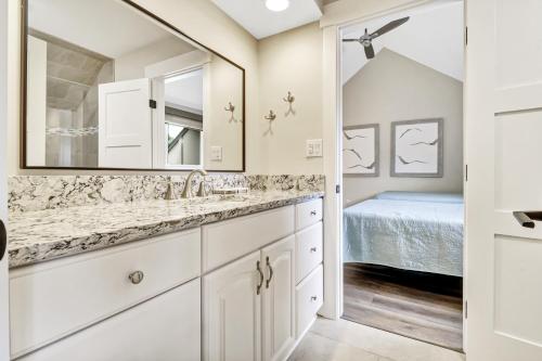 a bathroom with a sink and a mirror at 672 Queens Grant in Hilton Head Island