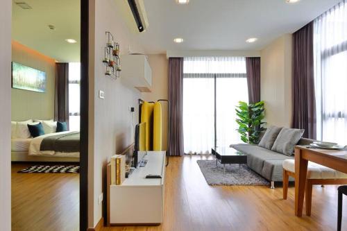 a living room with a couch and a bed at Stunning Spacious Mountain View Apartment in Chiang Mai