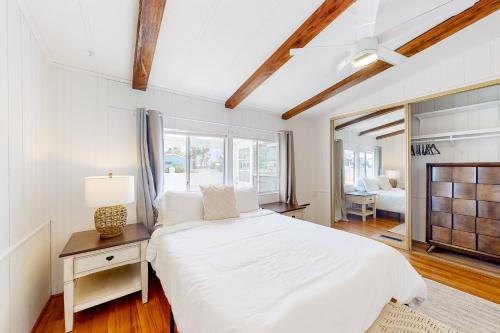 a white bedroom with a large bed and a window at Sky Valley Serenity in Rimlon