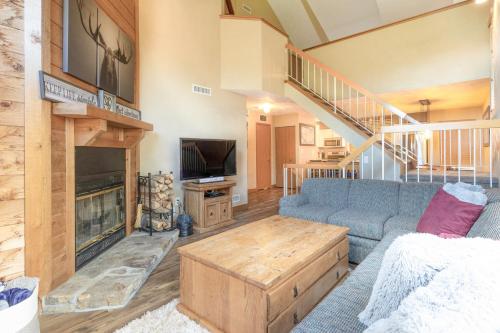 a living room with a couch and a fireplace at Seven Springs 2BRLoft Premium Condo, sleeps 11! condo in Champion