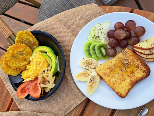 a plate with a bowl of food and a bowl of fruit at Glamping - Habla con la Luna in Santa Marta