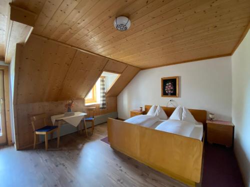 a bedroom with a large bed and a wooden ceiling at Bauernhof Helpferer in Ramsau am Dachstein