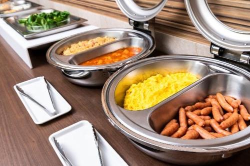 a counter with three trays of food on a table at Hotel Mark-1 CNT in Inzai