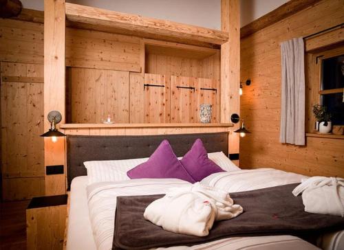 una camera con 2 letti con cuscini viola e bianchi di Chalet Schönbuchet a Mauth