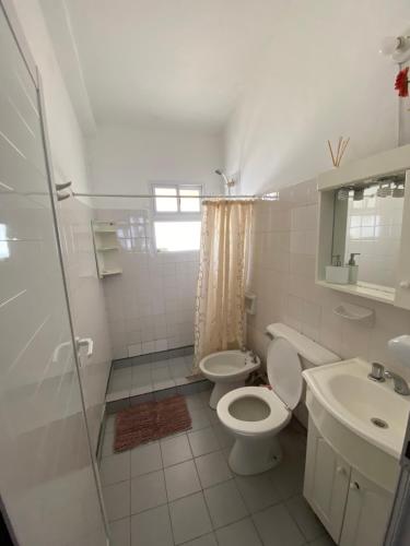 a bathroom with a toilet and a sink and a shower at AlejandraPacheco in Federación