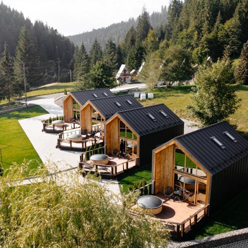 an overhead view of a row of wooden cabins at Terra Resort in Topliţa