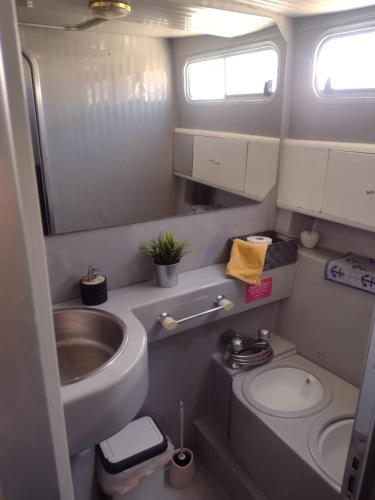 a small bathroom with a sink and a toilet at Yach Boat Experience in Barcelona