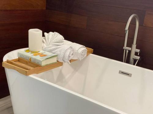 a bath tub with a sink with towels and a faucet at Sarasota Updated pool home, Near Siesta Key in Sarasota