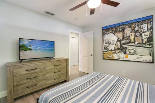 a bedroom with a flat screen tv on a dresser at Sarasota Updated pool home, Near Siesta Key in Sarasota