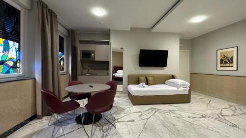 a room with a bed and a table and chairs at Allegroitalia La Spezia 5 Terre in La Spezia