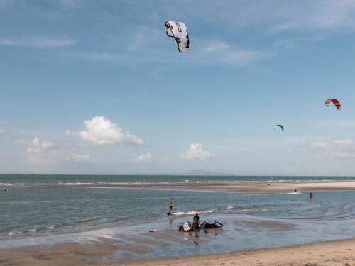a person riding a horse on the beach with a kite at Panama Kite Center in Punta Chame
